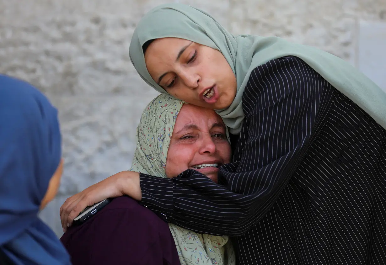 Mourners react during the funeral of Palestinians killed in Israeli strikes, amid the ongoing conflict between Israel and Hamas, at Al-Aqsa hospital, in Deir Al-Balah, in the central Gaza Strip