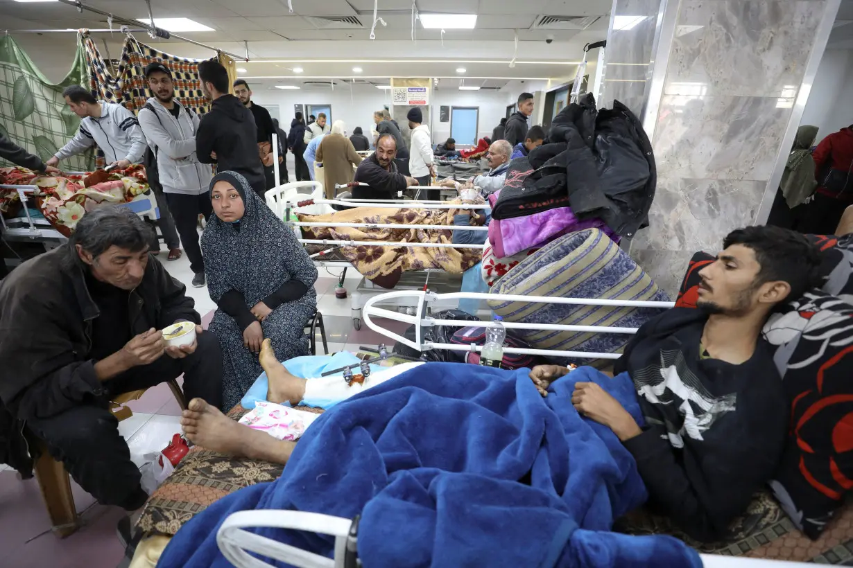 Palestinians who were wounded in Israeli fire while waiting for aid, according to health officials, lie on beds at Al Shifa hospital, amid the ongoing conflict between Israel and Hamas, in Gaza City