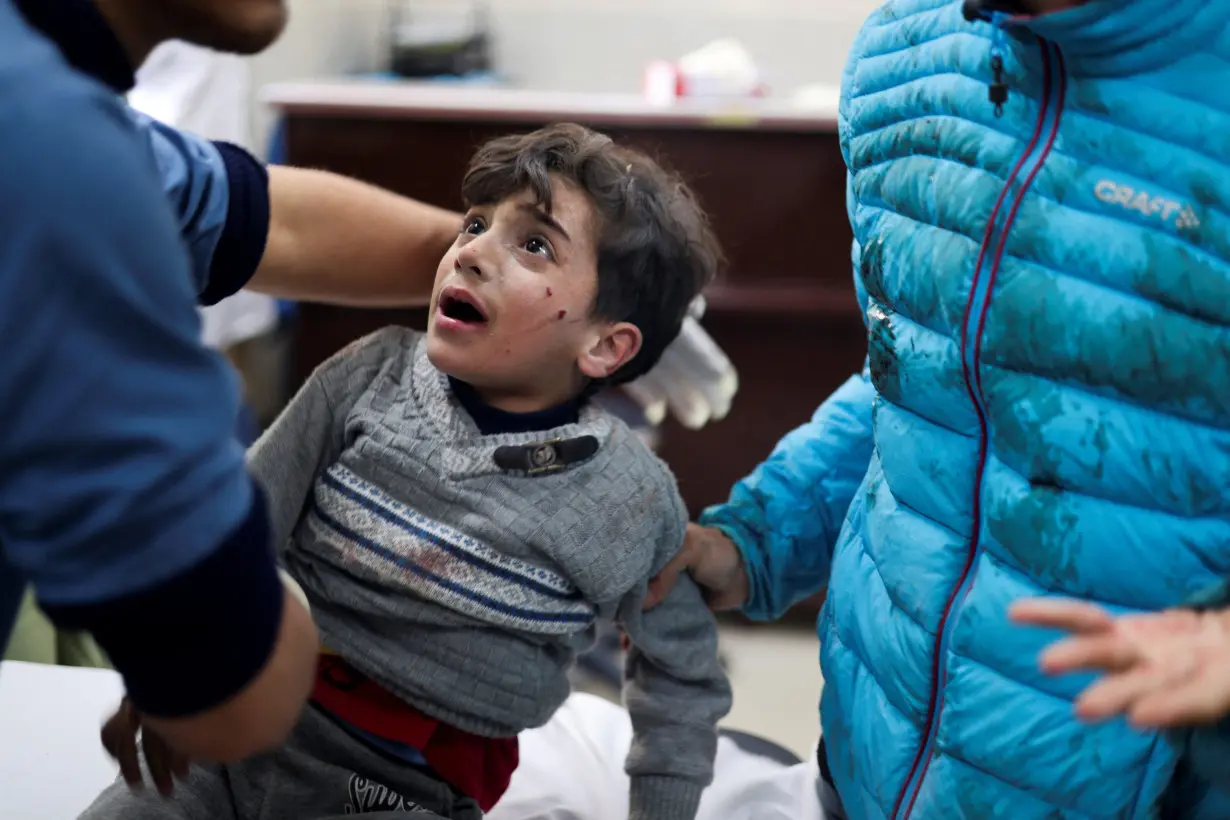 A Palestinian boy wounded in an Israeli strike is assisted in Kuwaiti Hospital, amid the ongoing conflict between Israel and the Palestinian Islamist group Hamas, in Rafah in the southern Gaza Strip