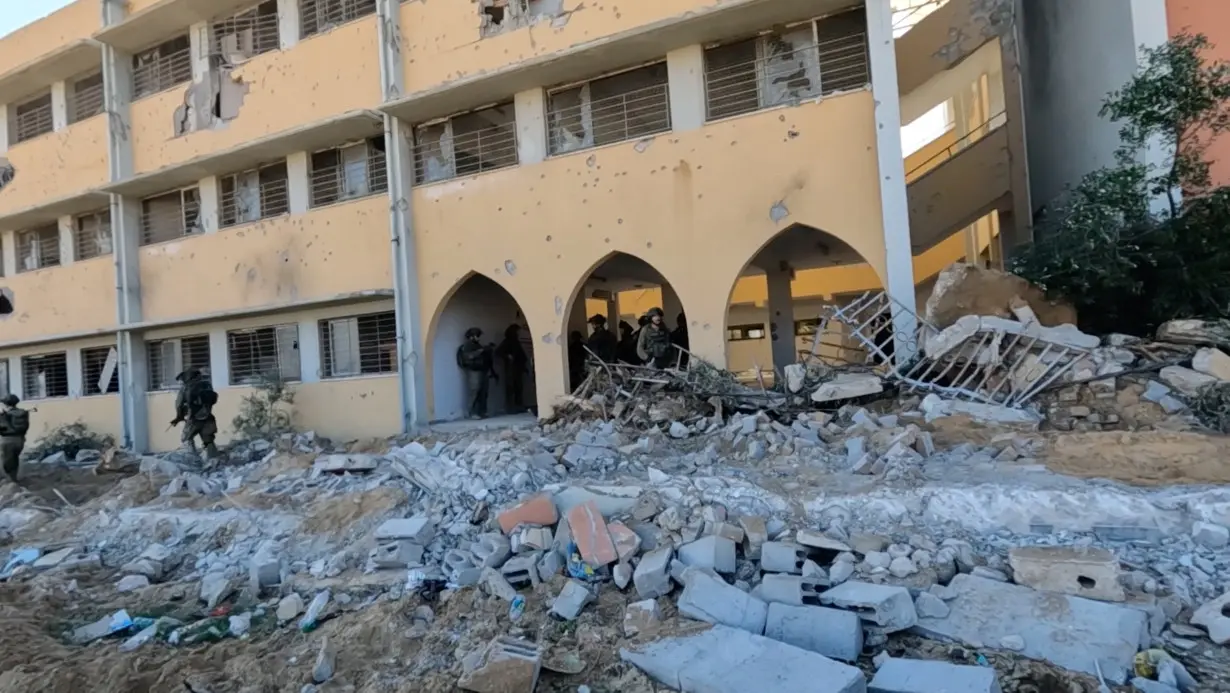 Israeli soldiers enter the school, near which the army located Hamas tunnel shaft, during the ongoing ground operation of the Israeli army against Palestinian Islamist group Hamas, in a location given as Beit Lahiya