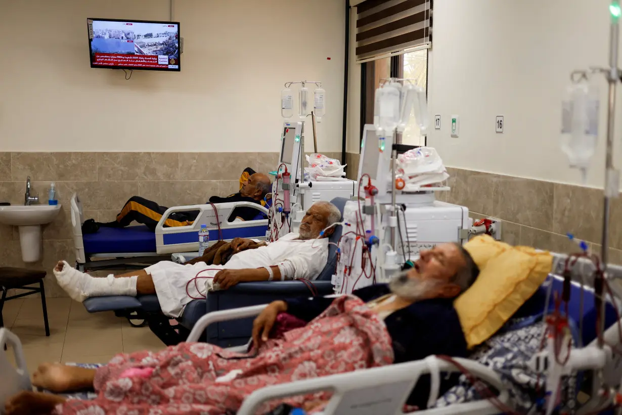 Palestinian kidney patients lie on hospital beds as health officials say they are running out of fuel to operate dialysis devices, amid the ongoing Israeli-Palestinian conflict, at Naser hospital in Khan Younis