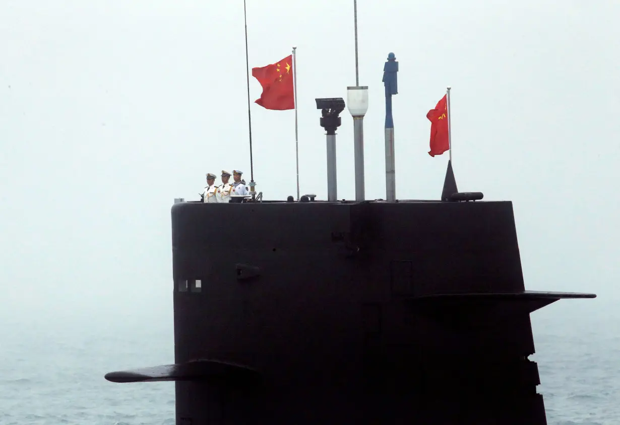 FILE PHOTO: A Chinese Navy's submarine takes part in a naval parade off the eastern port city of Qingdao to mark the 70th anniversary of the founding of Chinese People's Liberation Army Navy