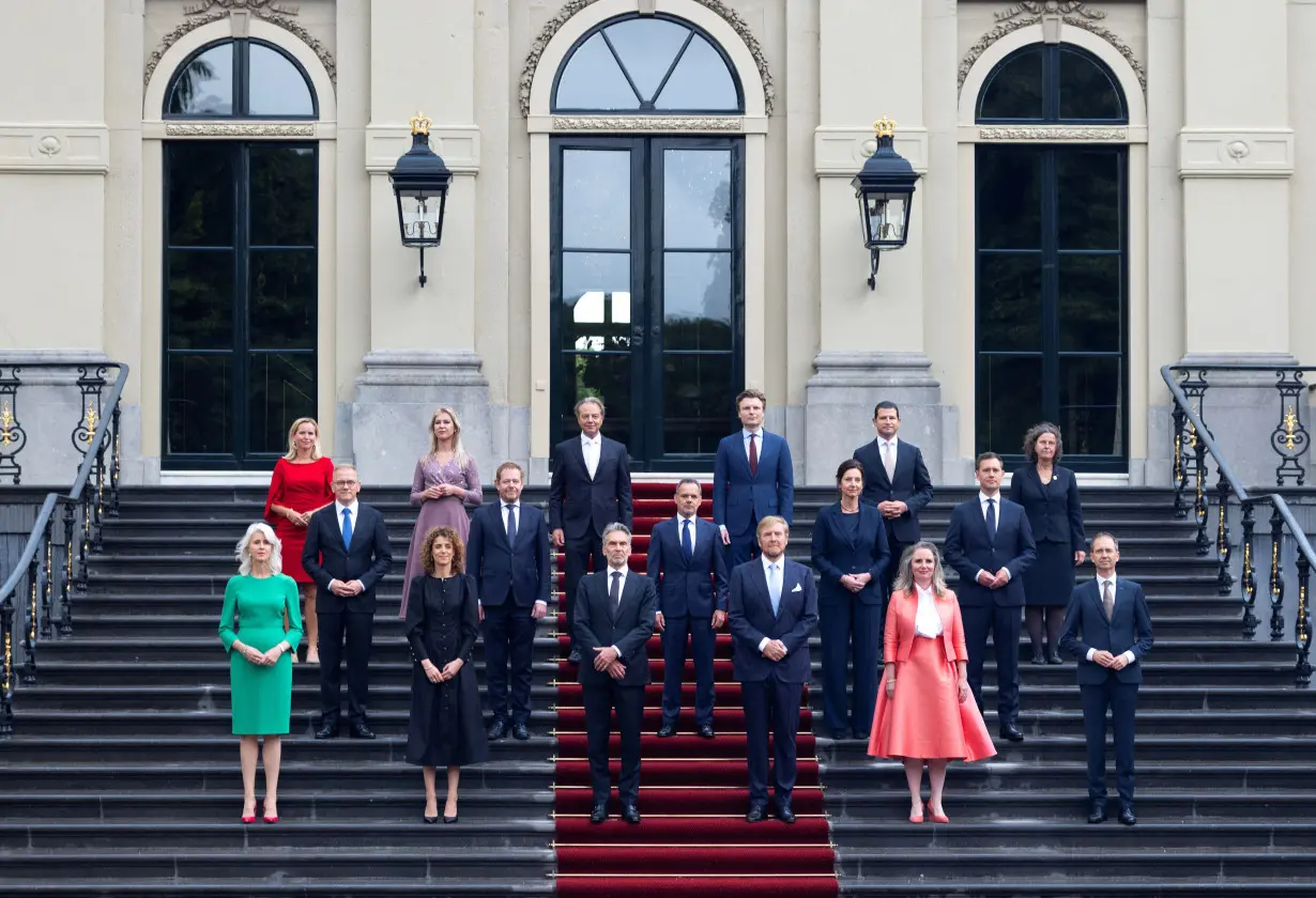 Dutch King Willem-Alexander and Prime Minister Dick Schoof pose with the new members of the Dutch Government