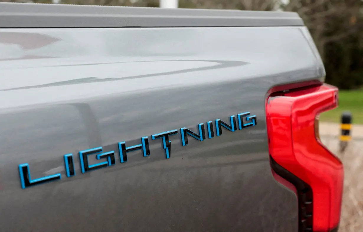 FILE PHOTO: The Lightning logo is seen on the side of an all-new Ford F-150 Lightning electric pickup truck outside the Ford Motor World Headquarters in Dearborn, Michigan, U.S., April 26, 2022. REUTERS/ Rebecca Cook/