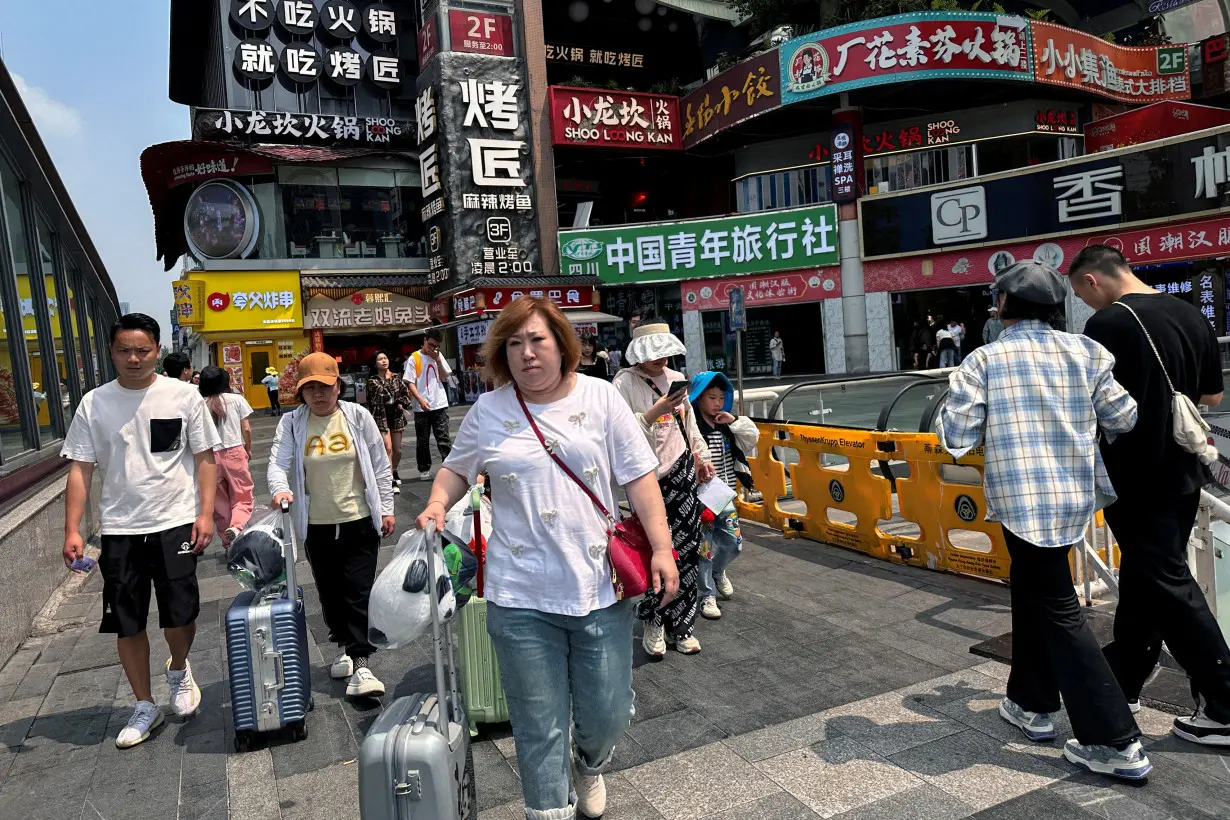 FILE PHOTO: People walk at a restaurant complex in Chengdu