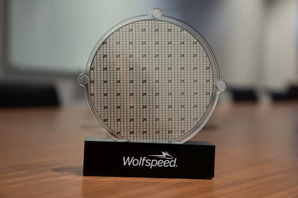 FILE PHOTO: U.S. power chip maker Wolfspeed’s silicon carbide 200mm wafer is seen on display at Wolfspeed’s Mohawk Valley Fab in Marcy, New York, U.S., April 2022. Silicon carbide power chips have been gaining traction with electric car makers as they