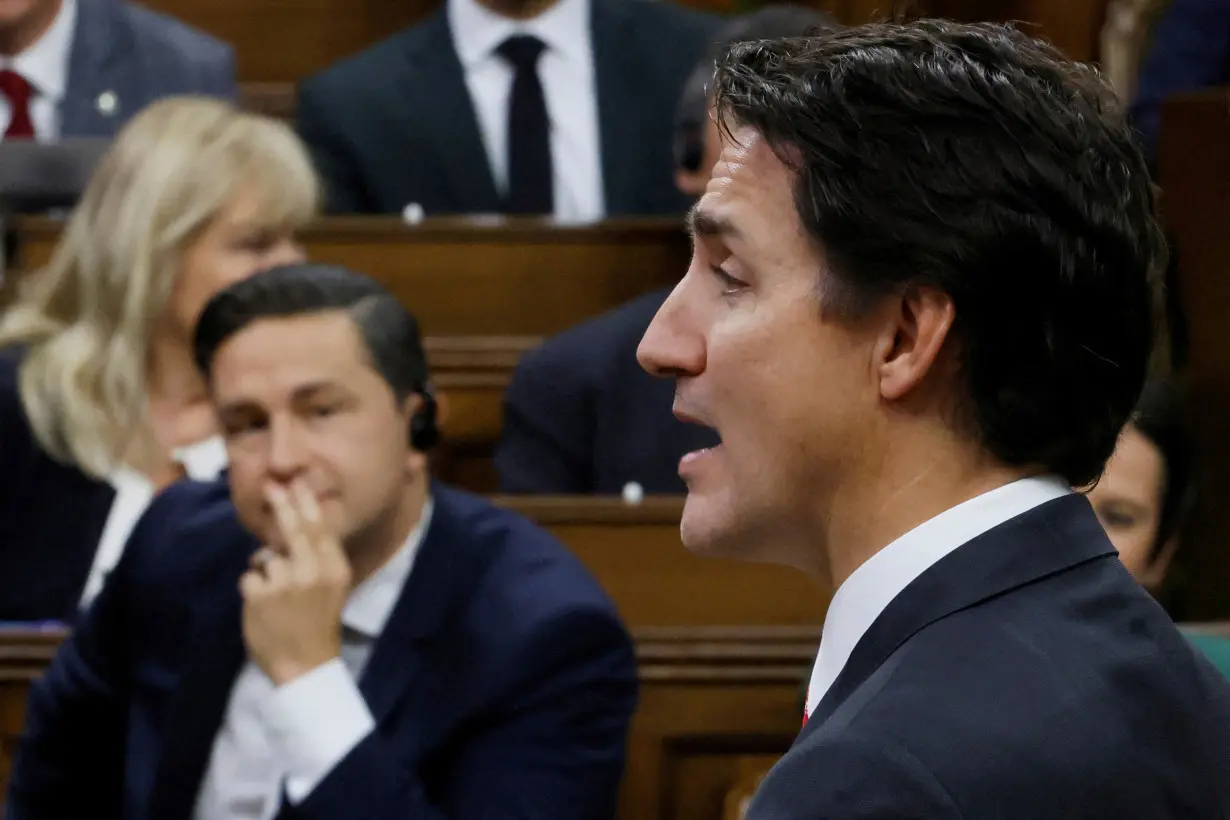 FILE PHOTO: Canada's Prime Minister Justin Trudeau speaks as Conservative Party of Canada leader Pierre Poilievre listens during Question Period in the House of Commons on Parliament Hill in Ottawa