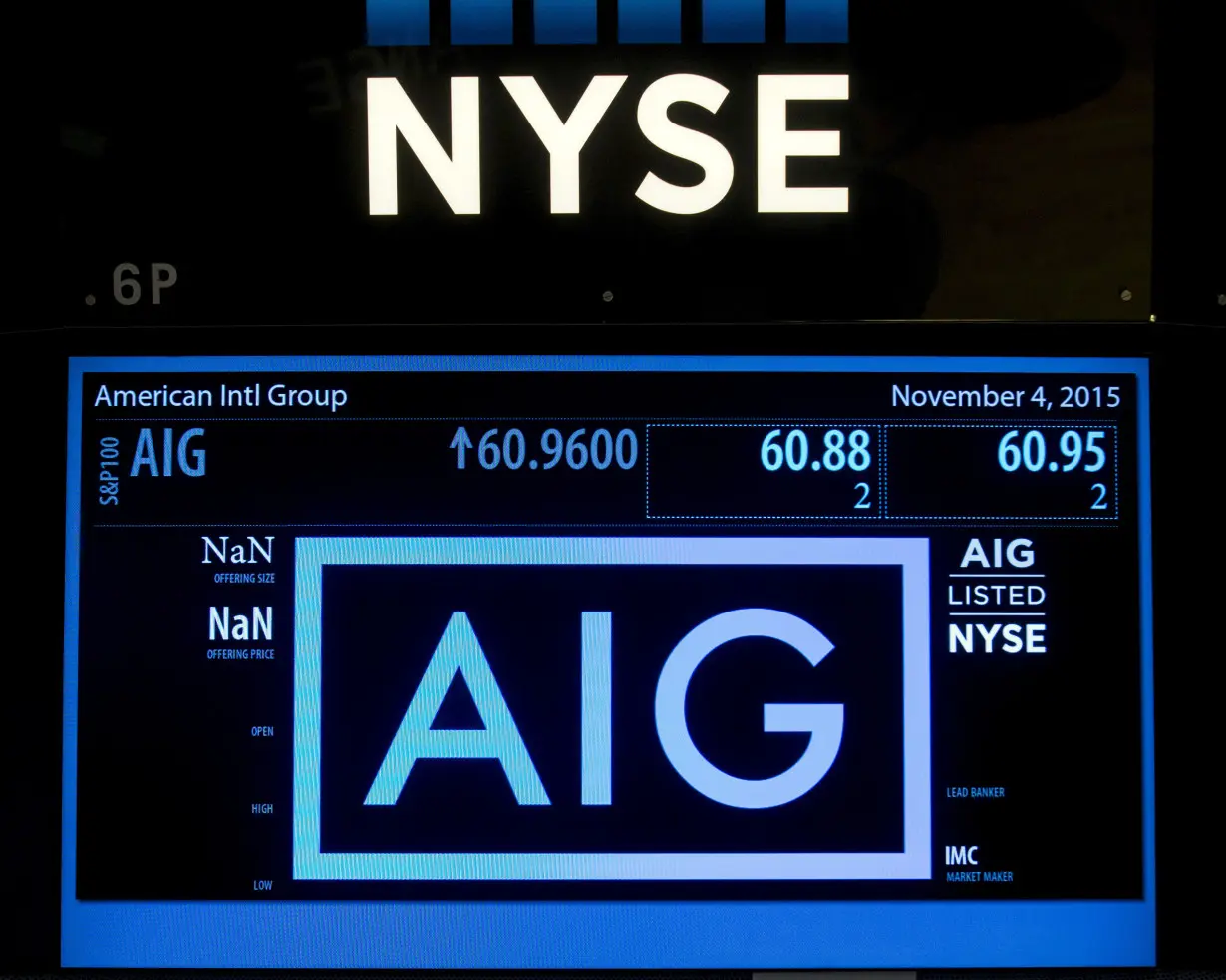 FILE PHOTO: The ticker information for insurance company American International Group Inc., (AIG) is displayed on a screen above the post where it is traded on the floor of the New York Stock Exchange