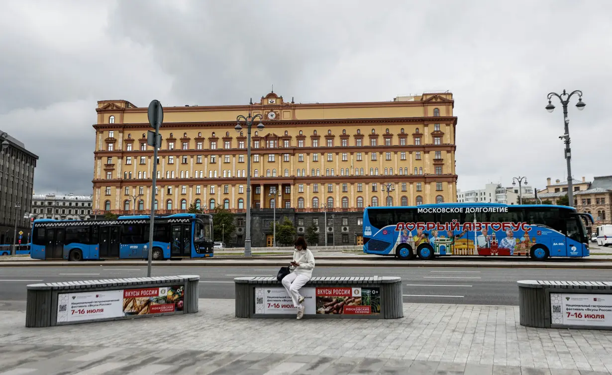 A woman uses her mobile phone in front of the Federal Security Service in Moscow