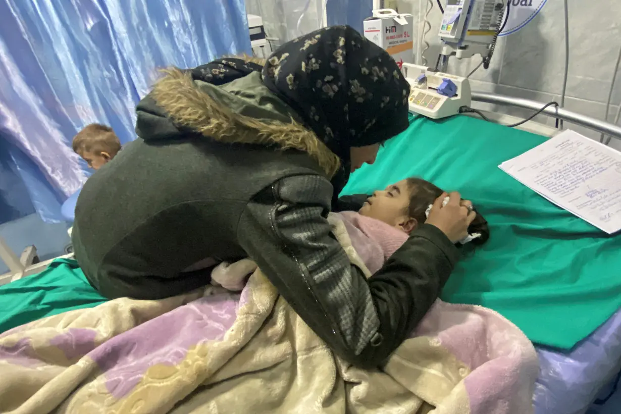 Palestinian mother Anwar Abdulnabi cries over the body of her daughter Mila, who had been suffering from deficiencies of calcium and potassium, at Kamal Adwan hospital on the edges of Beit Lahiya, in the northern Gaza Strip