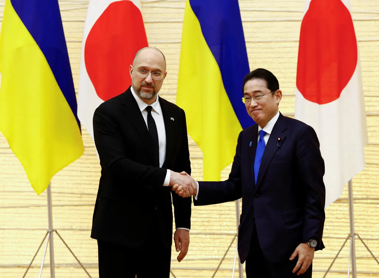 Ukraine's Prime Minister Denys Shmyhal shakes hands with Japanese Prime Minister Fumio Kishida after their joint press briefing as a part of the Japan-Ukraine Conference for Promotion of Economic Growth and Reconstruction in Tokyo