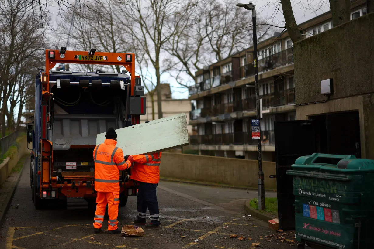 Refuse collectors work at a housing estate in south London