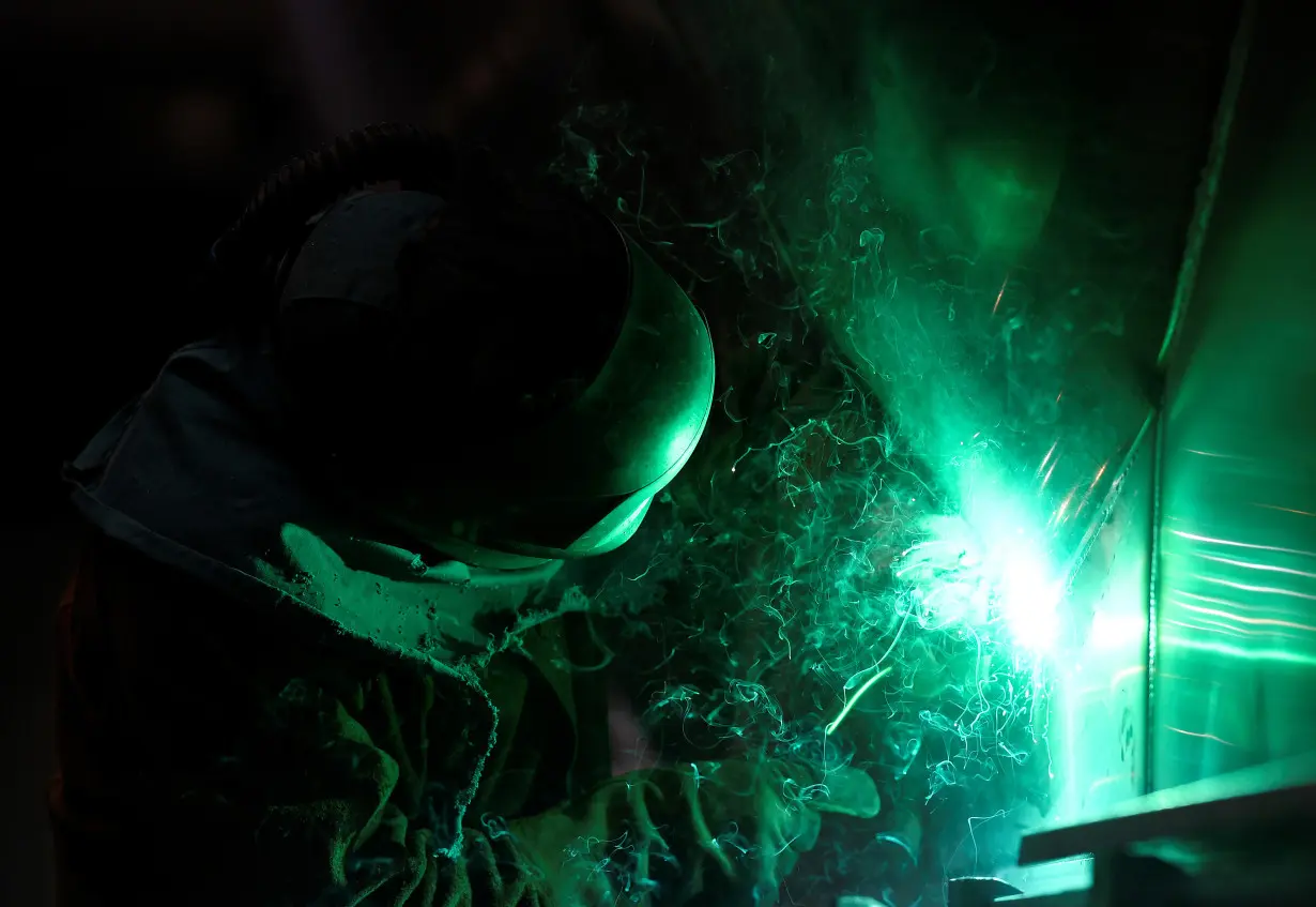 A worker at German manufacturer of silos and liquid tankers, Feldbinder Special Vehicles, welds aluminium at the company's plant in Winsen