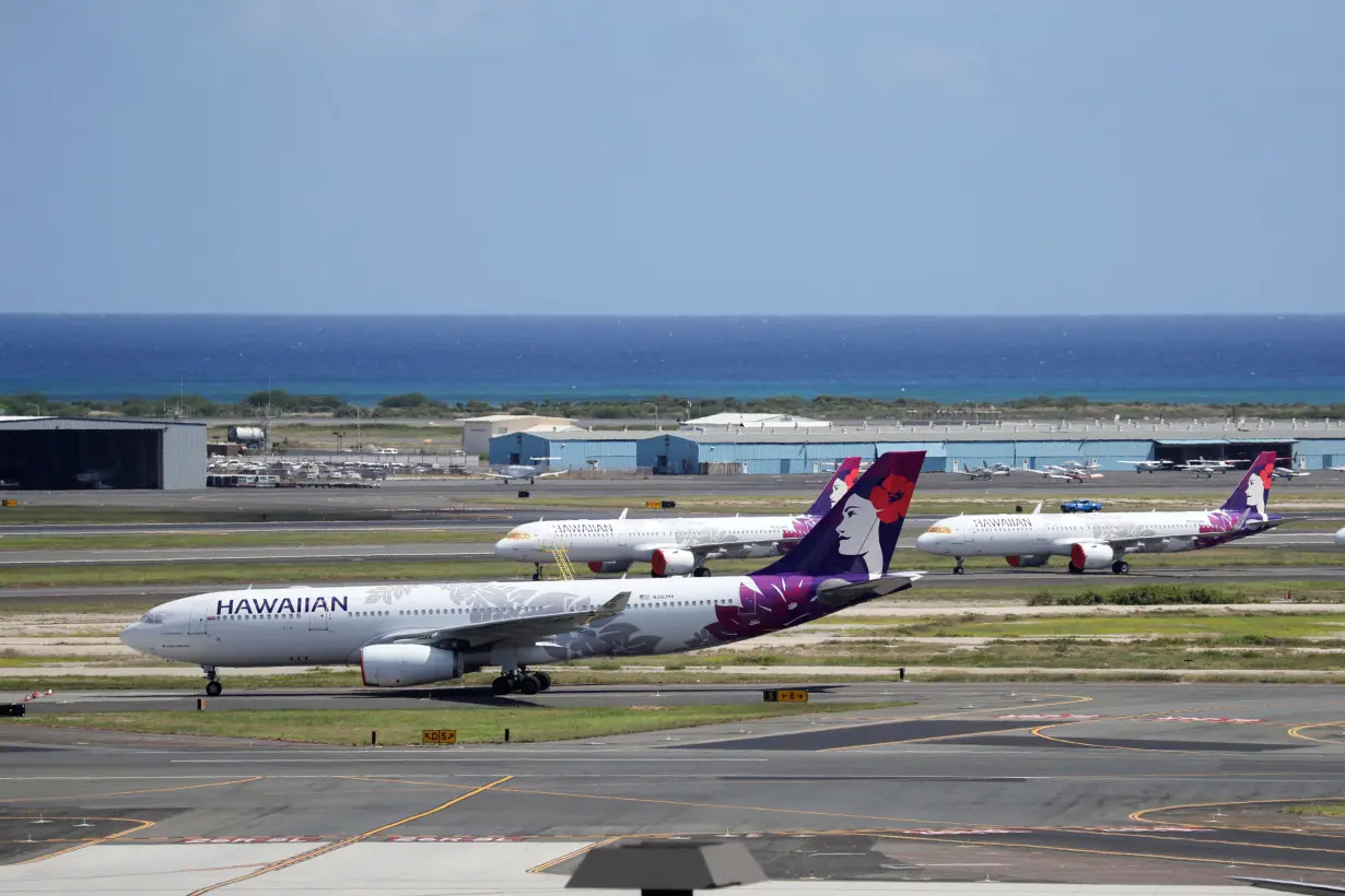 FILE PHOTO: Hawaiian Airlines airplanes sit idle on the runway at the Daniel K. Inouye International Airport due to the business downturn caused by the coronavirus disease (COVID-19) in Honolulu