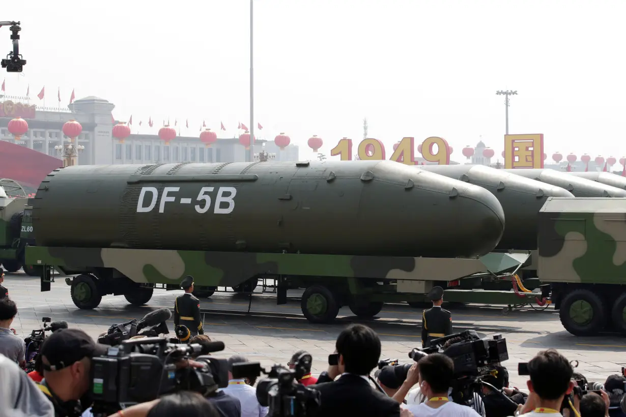 FILE PHOTO: Military vehicles carrying DF-5B intercontinental ballistic missiles travel past Tiananmen Square during the military parade marking the 70th founding anniversary of People's Republic of China