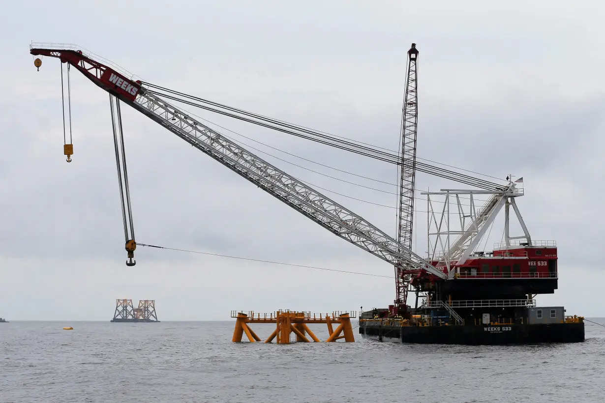 FILE PHOTO: A construction barge and crane float next to the first jacket (C) installed to support a turbine for a wind farm in the waters of the Atlantic Ocean off Block Island, Rhode Island July 27, 2015. REUTERS/Brian Snyder/