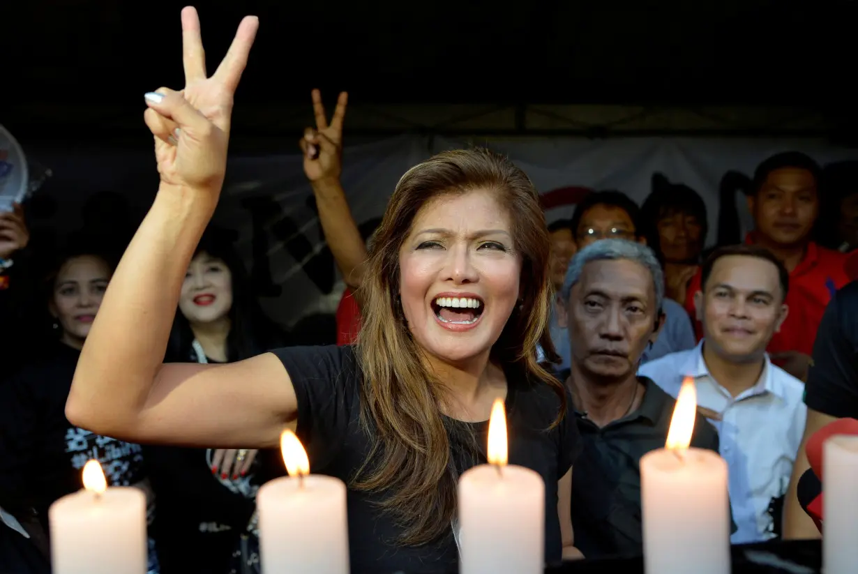 Governor Imee Marcos flashes the peace sign as she joins other supporters during a rally in front of the Supreme Court in Manila