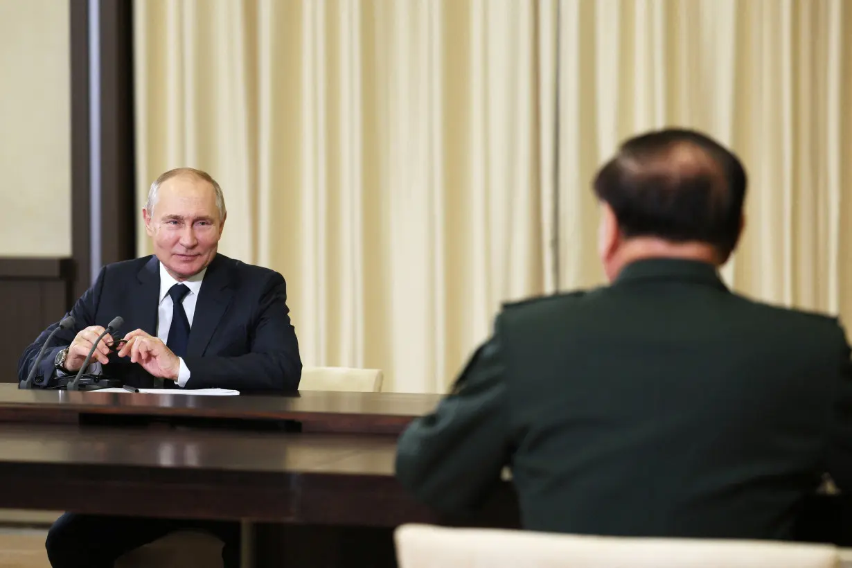 Russian President Vladimir Putin meets Defence Minister Sergei Shoigu and vice chairman of China's Central Military Commission General Zhang Youxia outside Moscow