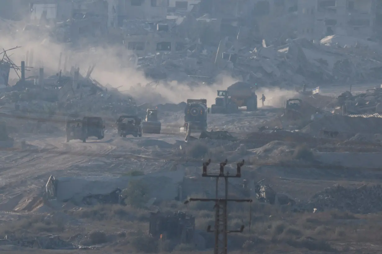 Israeli military vehicles and machinery drive inside Gaza, near the Israel-Gaza border, amid the Israel-Hamas conflict, as seen from Israel