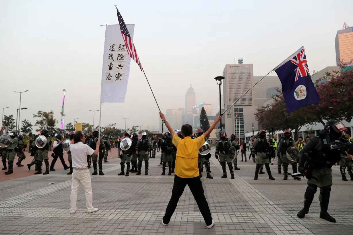 FILE PHOTO: Hong Kong protesters face off against riot police at a rally in support of the human rights of Xinjiang Uighurs in Hong Kong