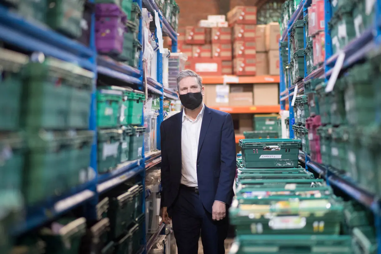 FILE PHOTO: British Labour Party leader Keir Starmer visits a food bank distribution centre in St Margaret The Queen church in Streatham