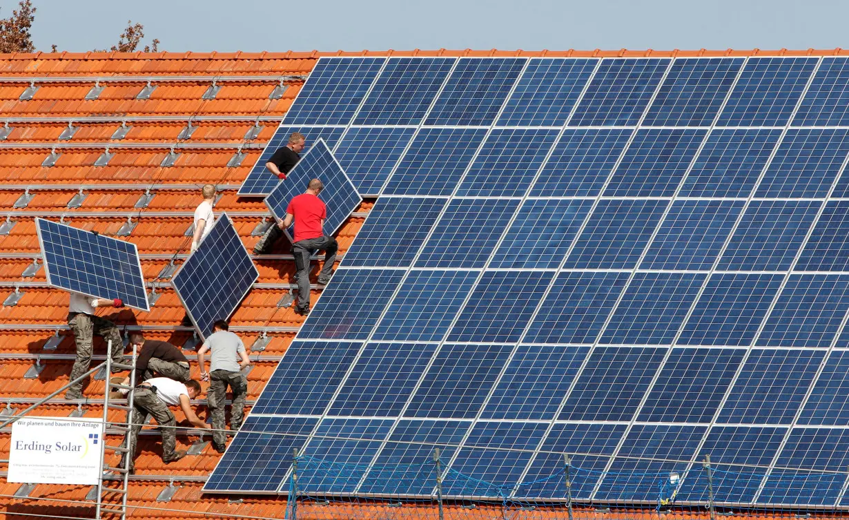 FILE PHOTO: Workers install 320 square metres of solar panels on roof of farmstead barn in Binsham