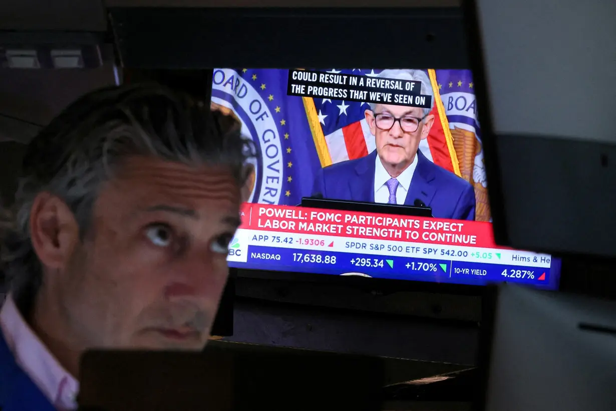 FILE PHOTO: Traders react to Fed rate announcement on the floor of the NYSE in New York