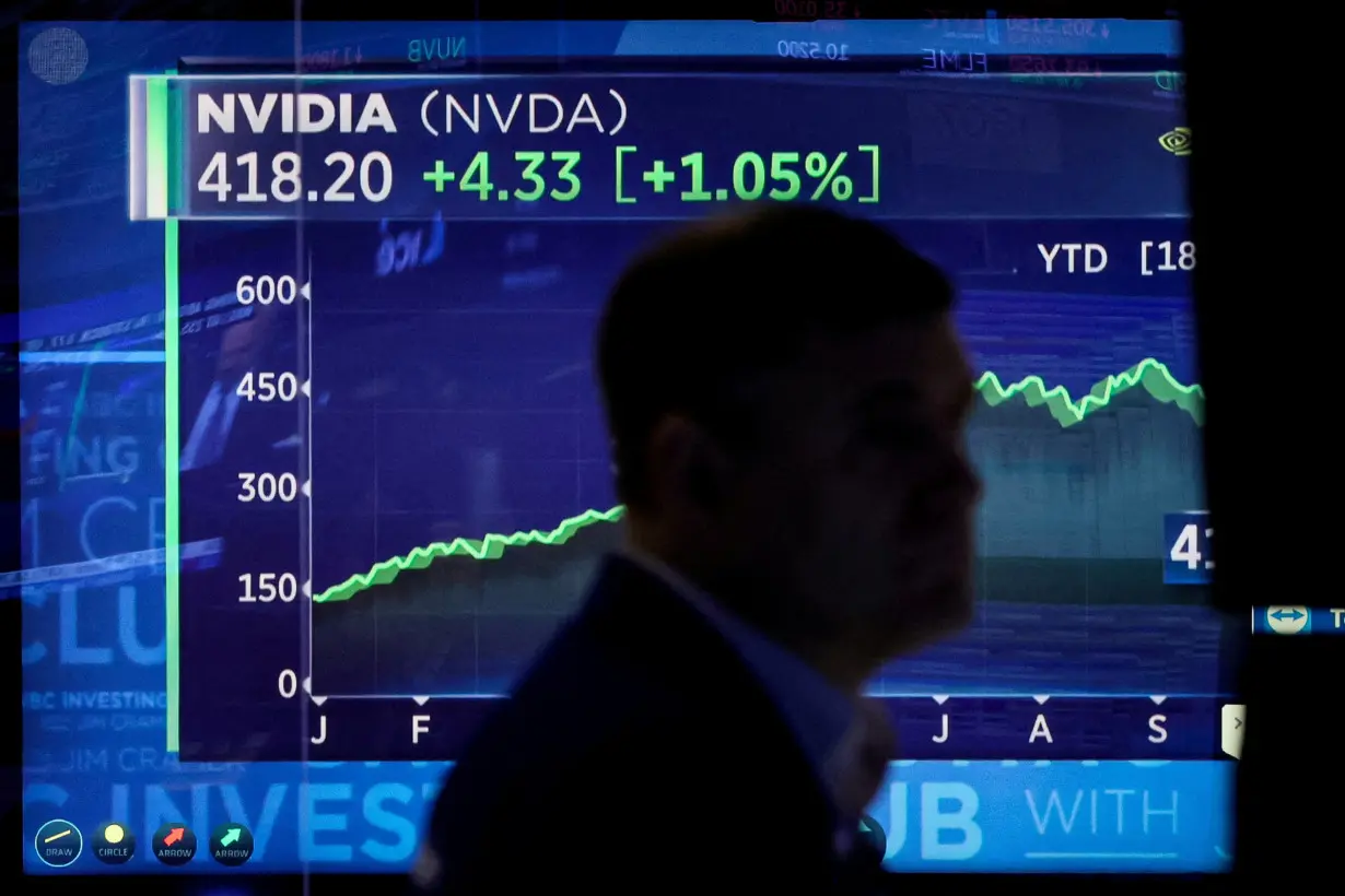 FILE PHOTO: Traders work on the floor of the NYSE in New York