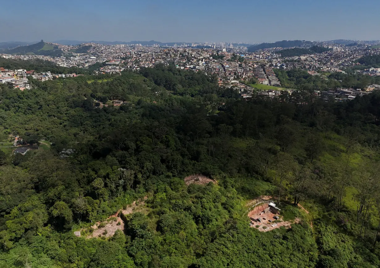 FILE PHOTO: A drone view shows the city and an area under permanent protection that was illegally deforested, in Maua