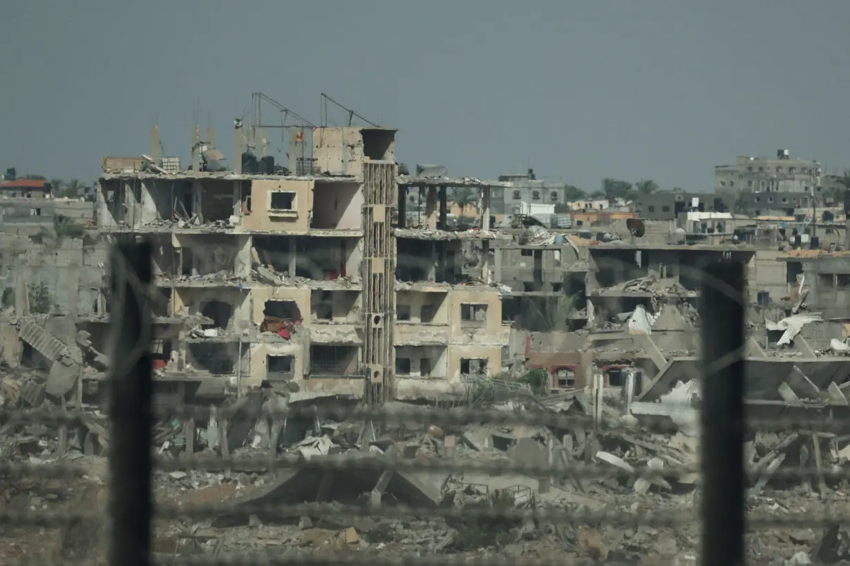 Remains of destroyed buildings in Gaza, amid the ongoing conflict between Hamas and Israel, are pictured through the Egypt-Gaza border, in Rafah