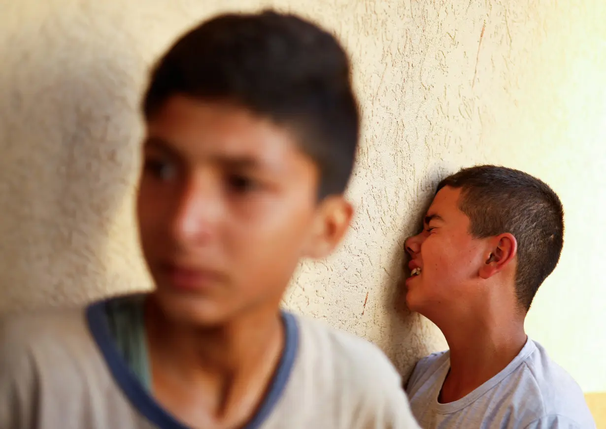 Mourners react next to the bodies of Palestinians killed in Israeli strikes in Khan Younis, in the southern Gaza Strip