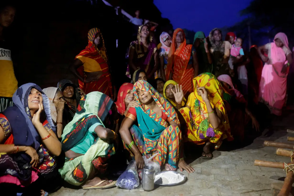 FILE PHOTO: Relatives mourn the death of stampede victims in Daunkeli, Hathras