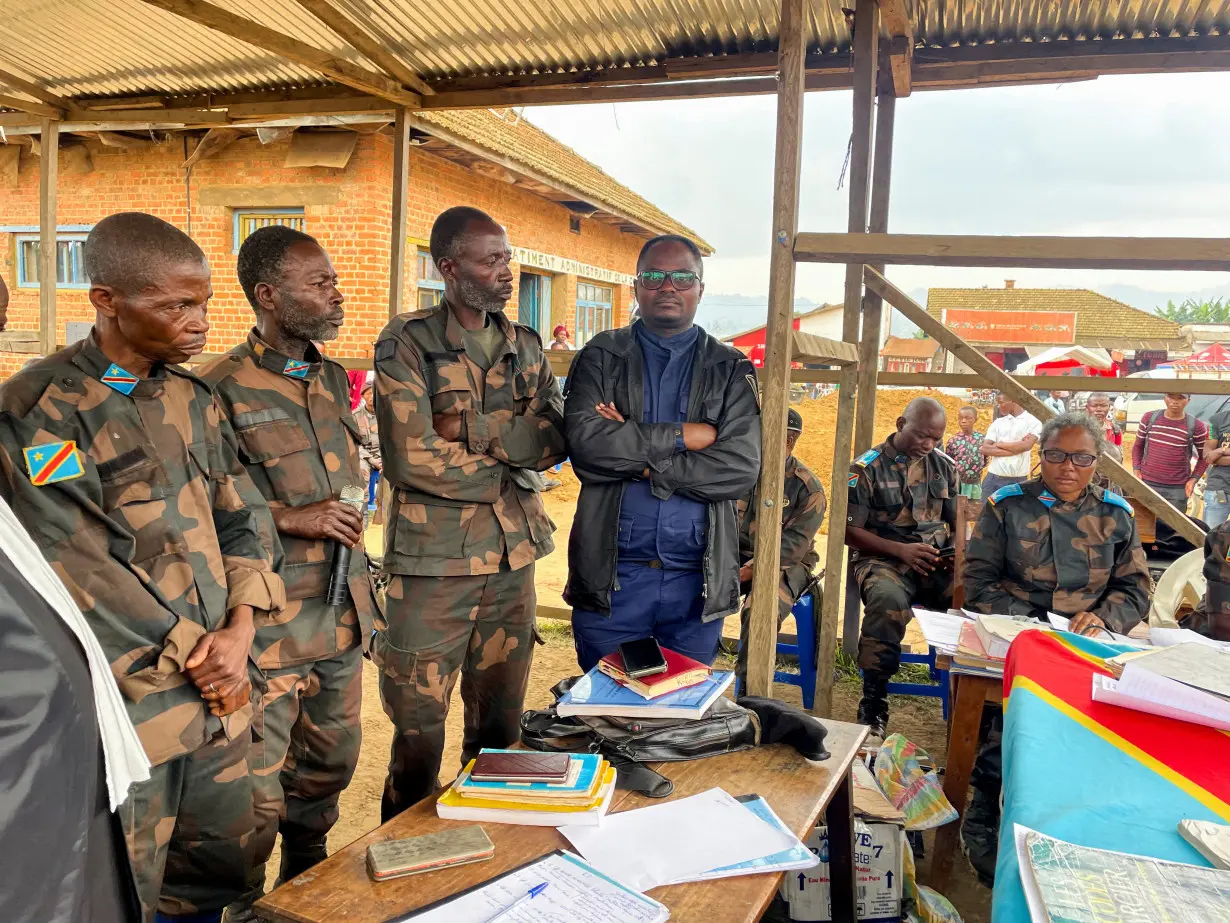 Group of Congolese soldiers, accused of fleeing combat against M23 rebels, take part in their trial, in Lubero