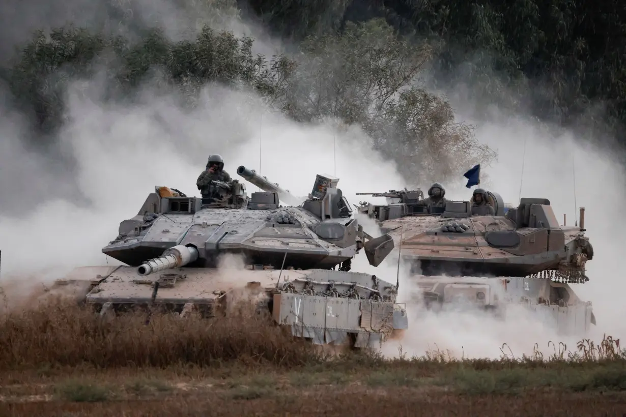 Israeli tanks manoeuvre near the border after entering Israel from Gaza, amid the Israel-Hamas conflict