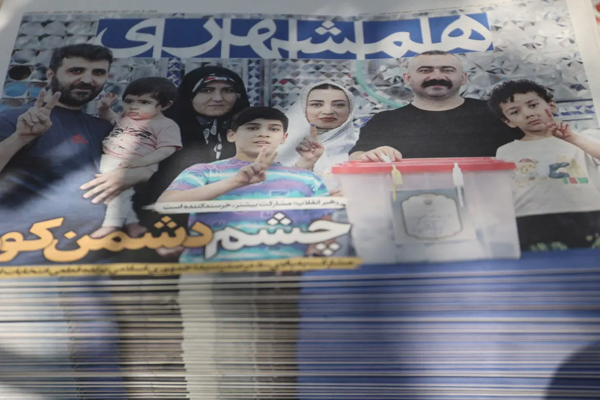 A newspaper with a cover picture of Iran's presidential election is seen in Tehran