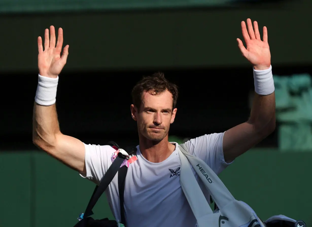 Andy Murray waves to the crowd after defeat in his second-round match.