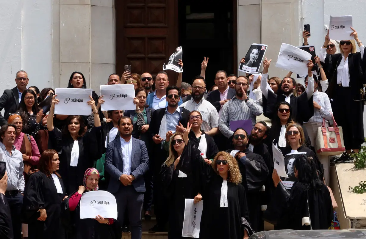 Lawyers carry banners during a protest outside the Palace of Justice building in Tunis