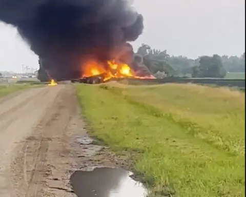 Fiery railcars with hazardous material mostly contained after derailment in North Dakota