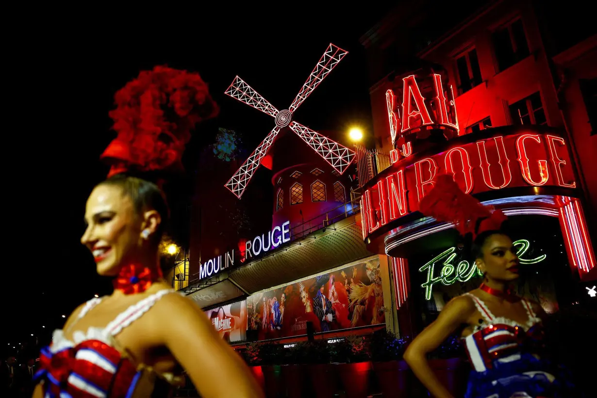 The iconic Moulin Rouge windmill in Paris, France, has blades again after they fell off in April.