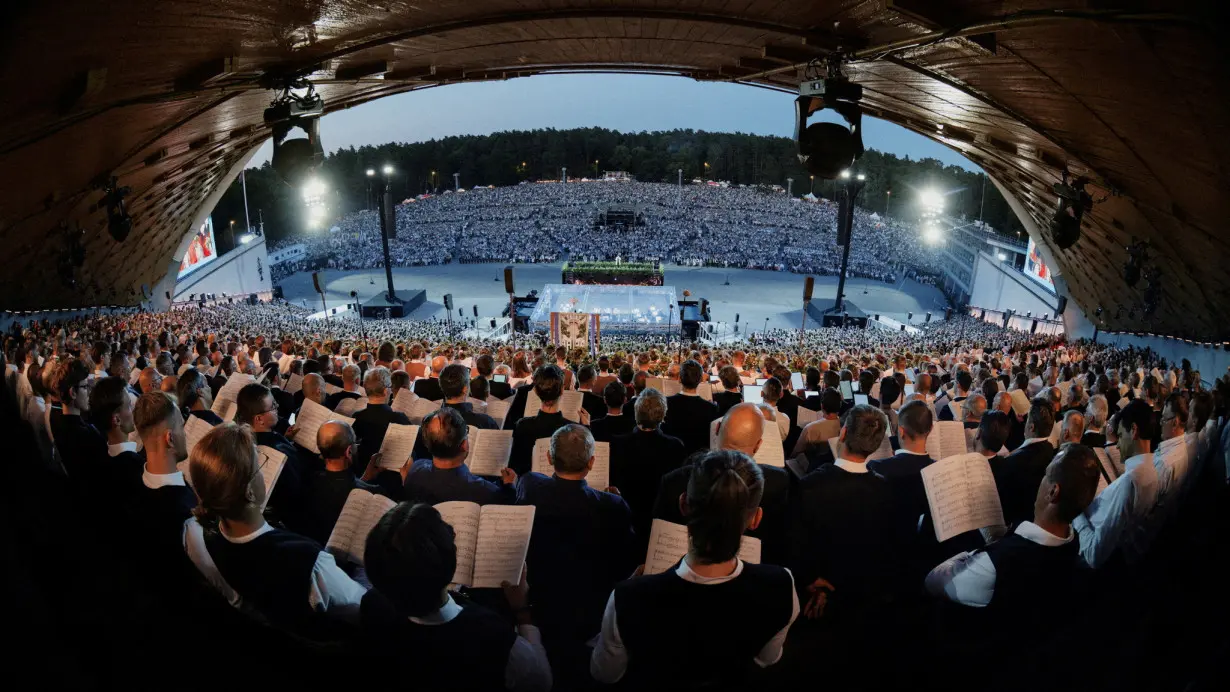 A view from the performers' tribune shows people singing the national anthem as part of a global celebration,in Vilnius