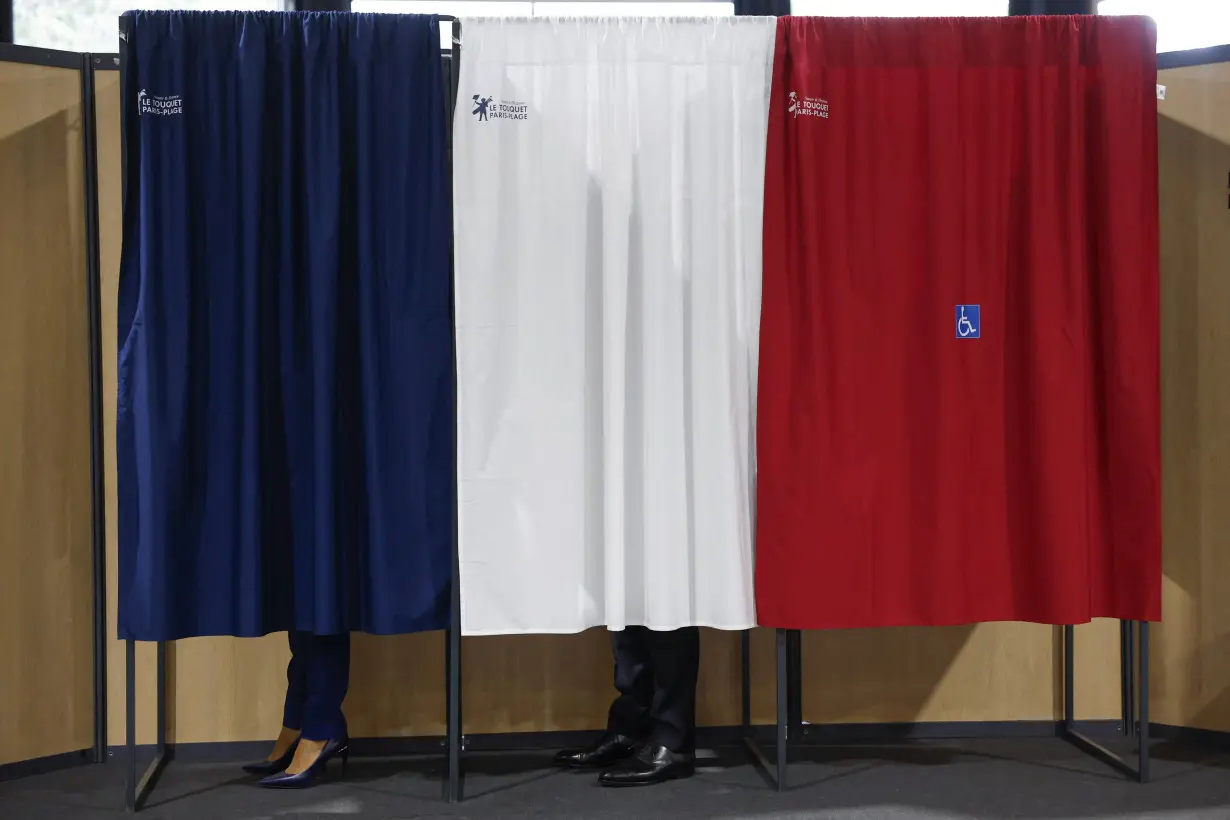 French President Macron votes in the second round of French parliamentary elections