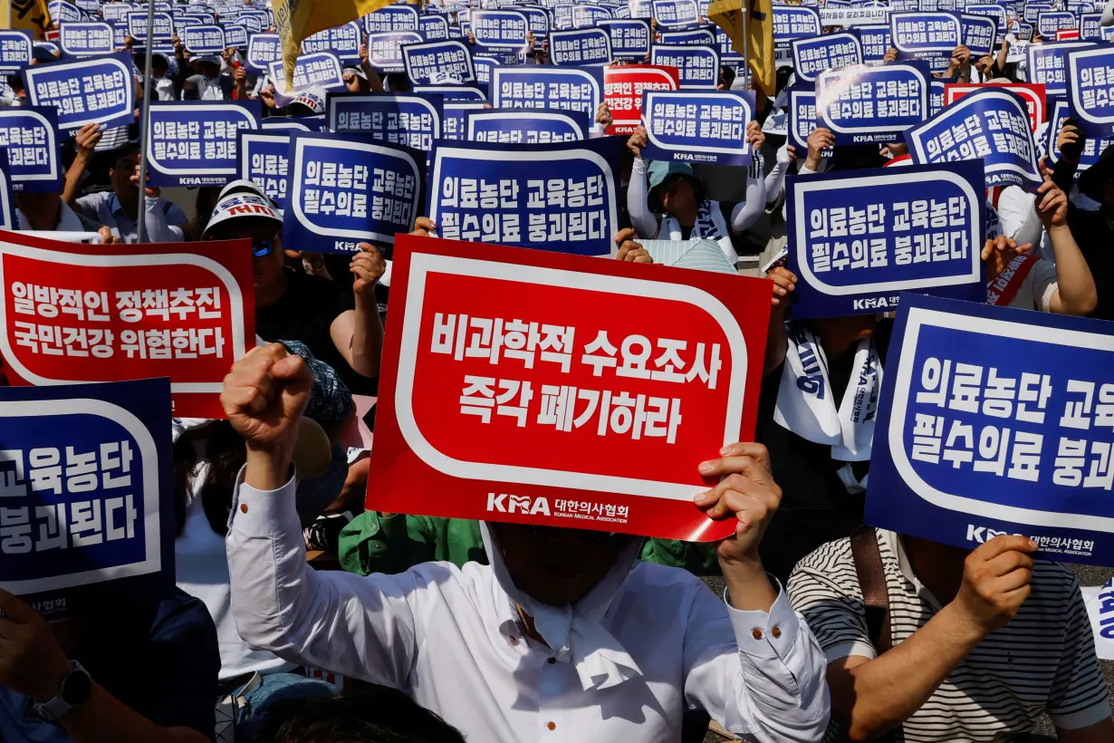 FILE PHOTO: Doctors strike and shout slogans during a rally to protest against government plans to increase medical school admissions and healthcare reform in Seoul