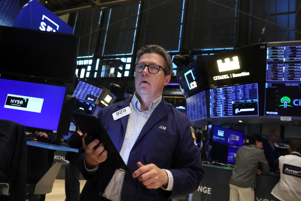 Traders work on the floor of the NYSE in New York