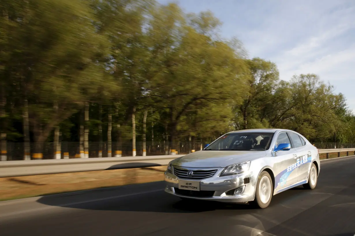 Changan Automobile's self-driving car, a modified Raeton sedan, is seen during a test drive on a highway in Beijing