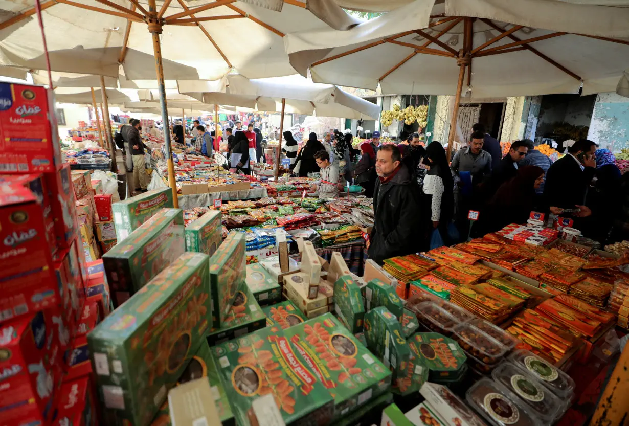 People shop at a popular market in downtown Cairo