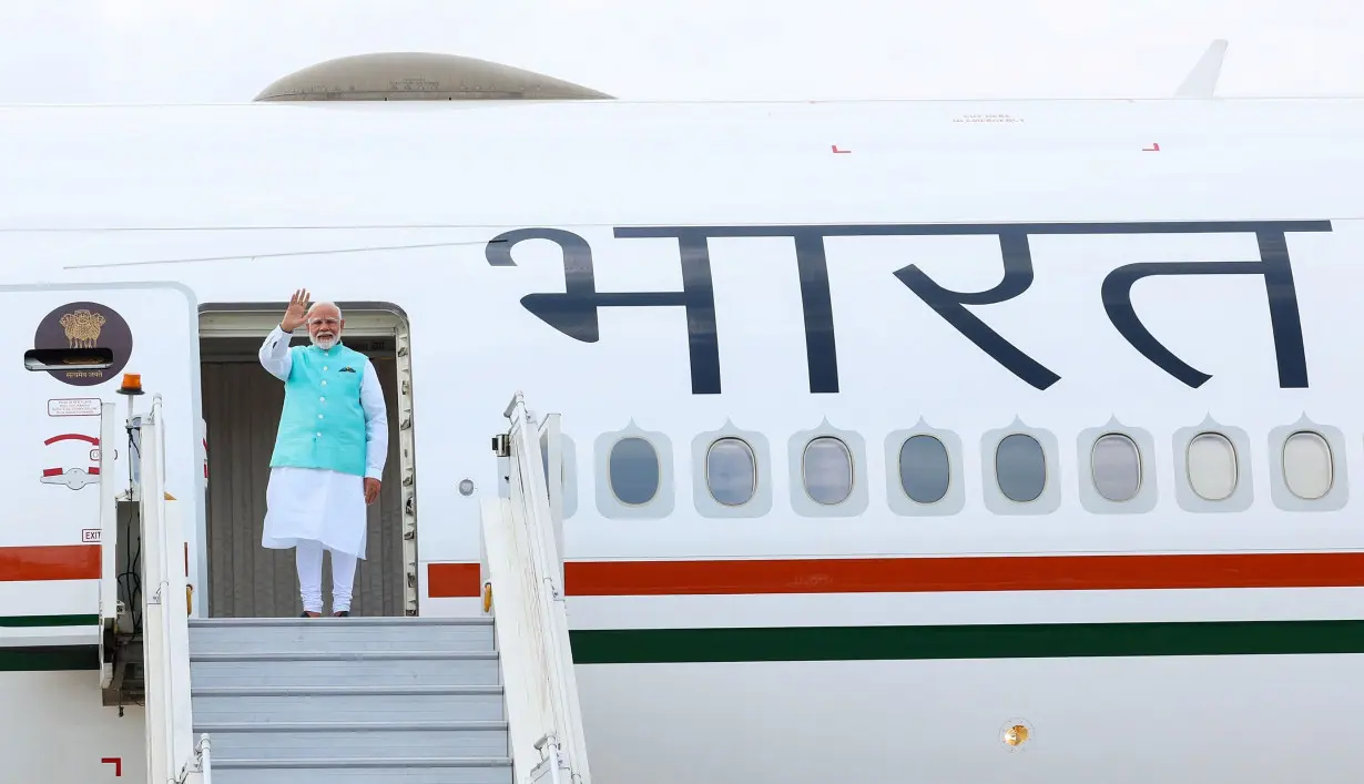 Prime Minister Narendra Modi boards his plane ahead of a visits to Russia and Austria, in New Delhi on Monday.