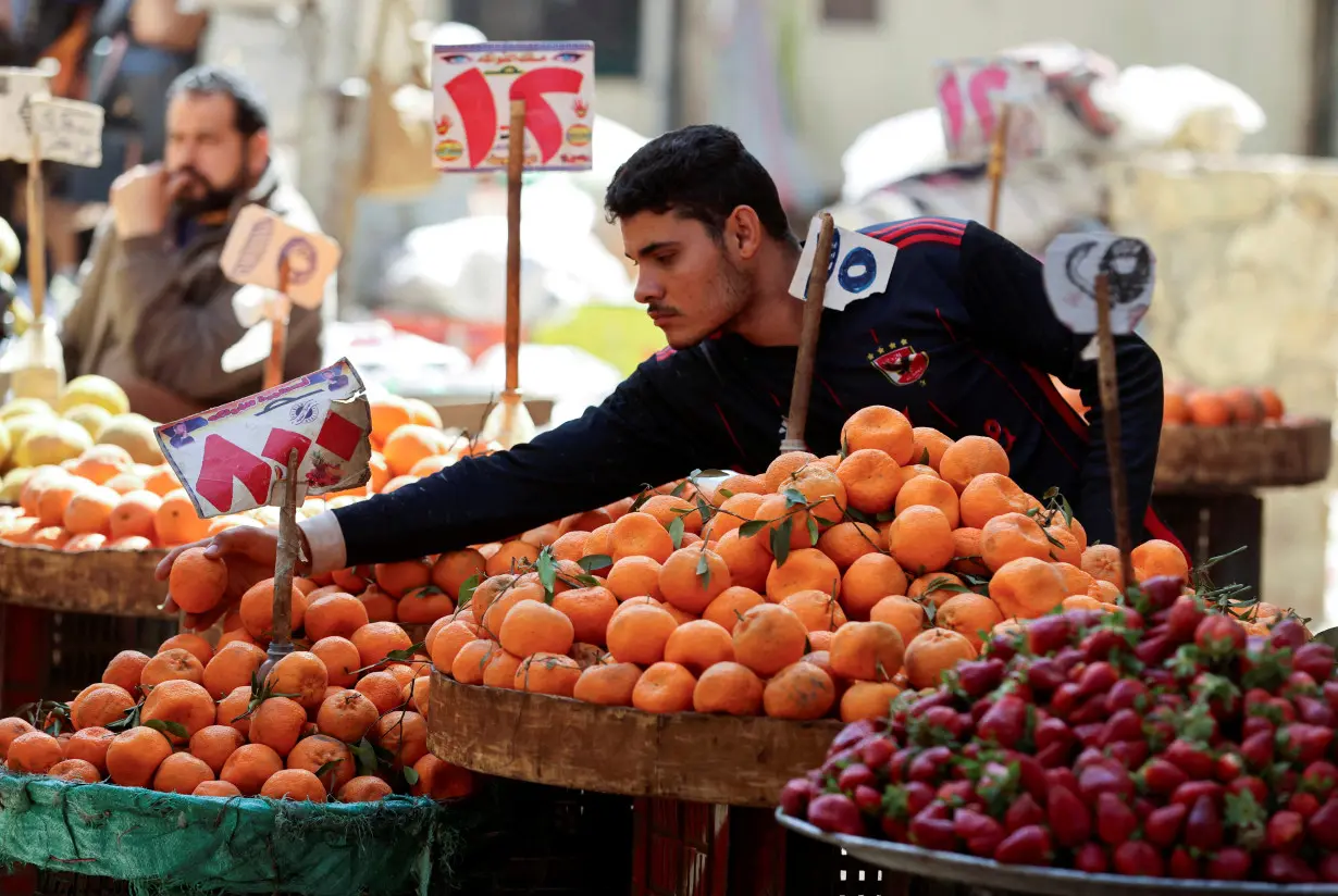 An Egyptian fruit seller works at a market in Cairo