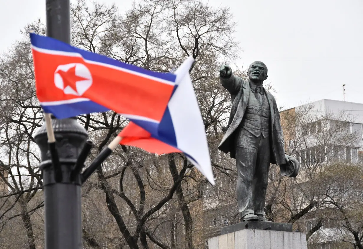 FILE PHOTO: State flags of Russia and North Korea fly in a street in Vladivostok