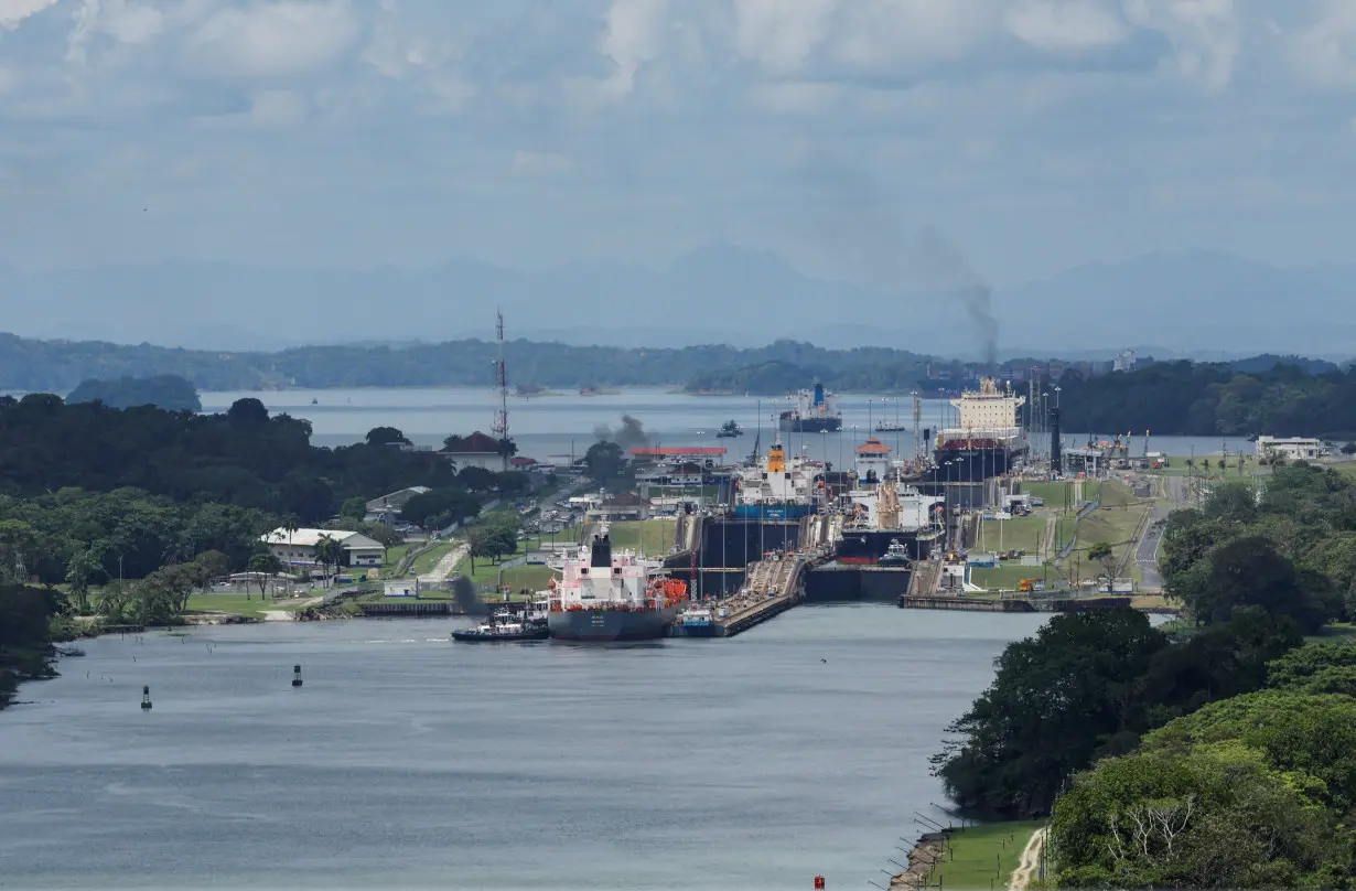 Cargo vessels transit through the Panama Canal, in Colon