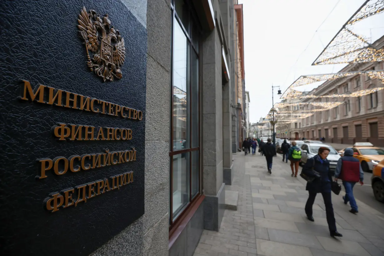 Pedestrians walk past Russia's Finance Ministry building in Moscow